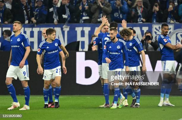 Schalke's French defender Florent Mollet celebrates scoring the opening goal with his teammates during the German first division Bundesliga football...