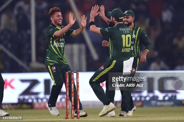 Pakistan's Zaman Khan celebrates with teammates after taking the wicket of New Zealand's Chad Bowes during the first Twenty20 cricket match between...
