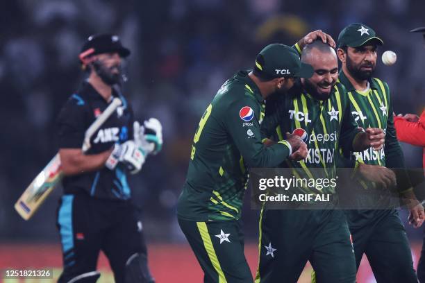 Pakistan's Faheem Ashraf celebrates with teammates after taking the wicket of New Zealand's Daryl Mitchell during the first Twenty20 cricket match...