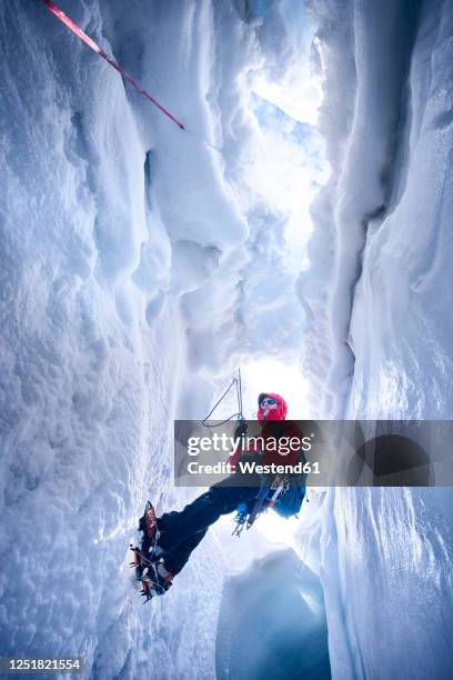 mountaineer climbing in crevasse, glacier grossvendediger, tyrol, austria - crevice stock pictures, royalty-free photos & images