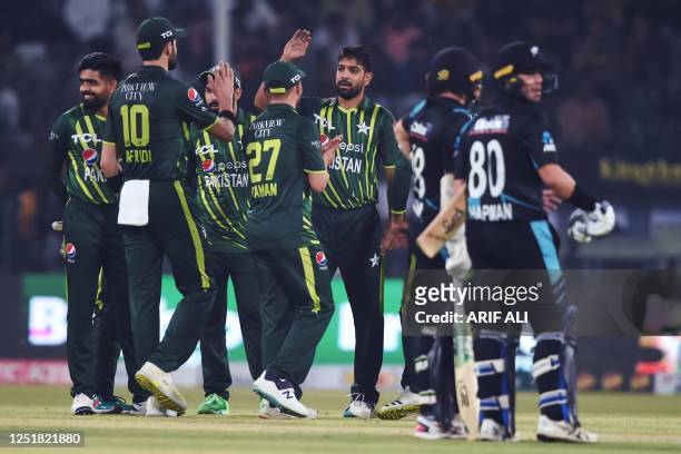 Pakistan's Haris Rauf celebrates with teammates after taking the wicket of New Zealand's captain Tom Latham during the first Twenty20 cricket match...