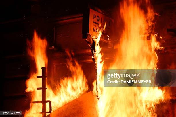 Photograph shows the frontage of a police station on fire during a demonstration, after France's Constitutional Council approved the key elements of...