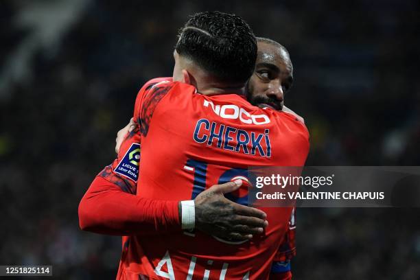 Lyon's French midfielder Rayan Cherki is congratulated by Lyon's French forward Alexandre Lacazette after he scores his team's second goal during the...