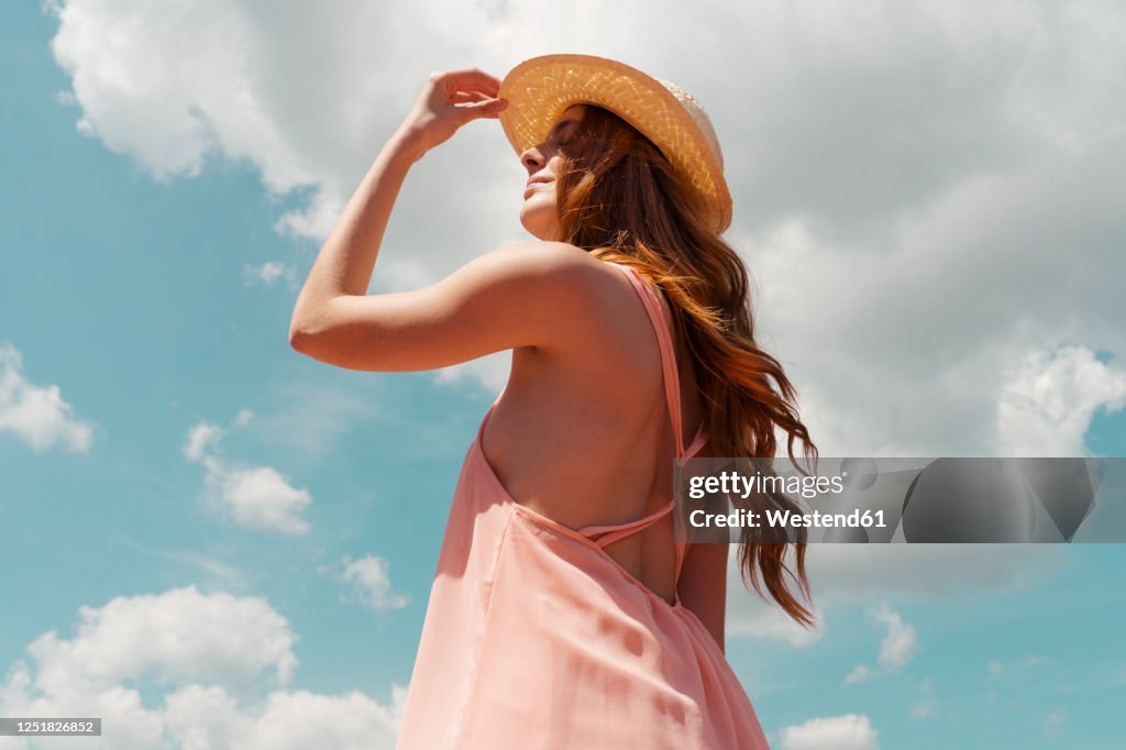 Portrait of redheaded woman enjoying sunlight