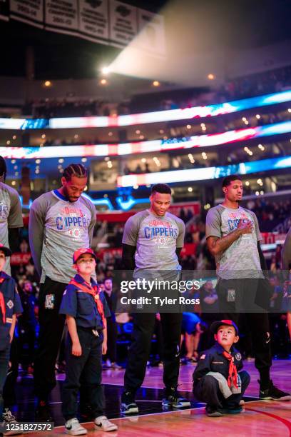 Kawhi Leonard, Russell Westbrook and Paul George of the LA Clippers stand for the National Anthem before the game against the Toronto Raptors on...