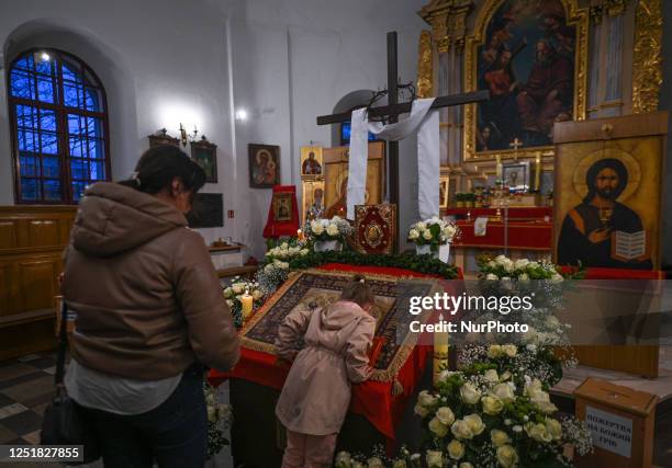 Young worshipper kisses the Holy Shroud during the Good Friday service at the Dormition of the Virgin Mary Greek Catholic parish, on April 14 in...