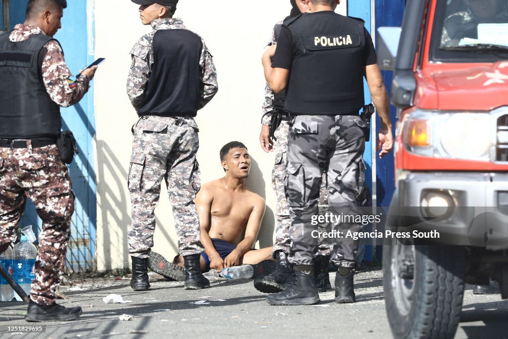 A inmate is kept arrested by guards after a riot on April 14, 2023 in ...