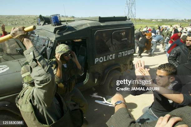 Protester scuffles with an Israeli soldier during a demonstration against the controversial Israeli separation barrier in the West Bank village of...