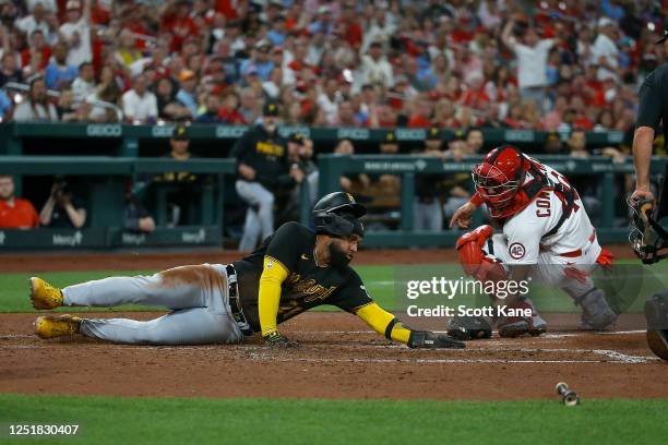 Canaan Smith-Njigba of the Pittsburgh Pirates is tagged out by Willson Contreras of the St. Louis Cardinals during the fourth inning at Busch Stadium...