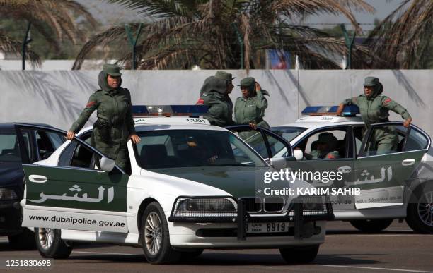 Dubai policewomen with an elite squad for VIPs show their skills during a graduation ceremony in the Gulf emirate on April 15, 2009. In the male...