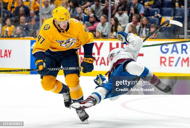 Michael McCarron of the Nashville Predators hits Devon Toews of the Colorado Avalanche during an NHL game at Bridgestone Arena on April 14, 2023 in...