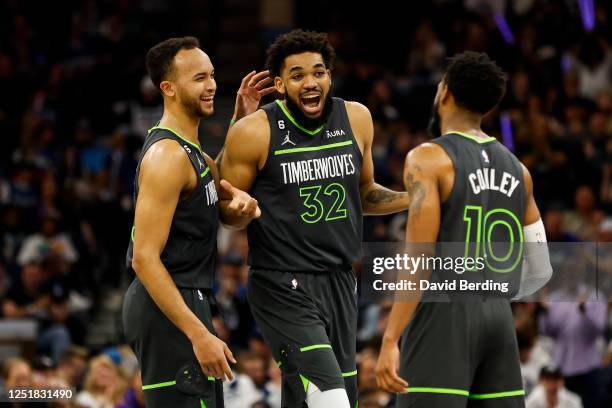 Karl-Anthony Towns of the Minnesota Timberwolves celebrates drawing a foul against Oklahoma City Thunder with teammates Kyle Anderson and Mike Conley...