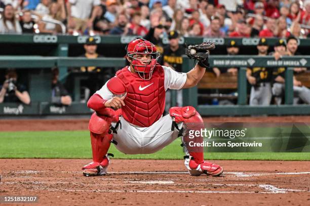 St. Louis Cardinals catcher Willson Contreras shows the umpire he held on to the ball after the play at the plate during a game between the...