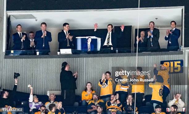 Nashville Predators retiring General Manager David Poile waves to fans during a celebration of his tenure during an NHL game against the Colorado...