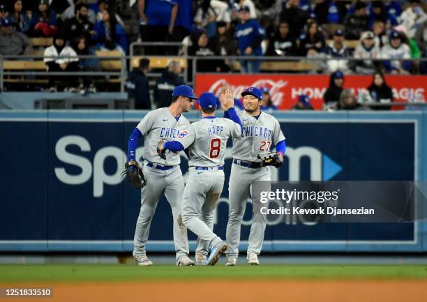 Seiya Suzuki, Ian Happ and Cody Bellinger of the Chicago Cubs celebrate after defeating the Los Angeles Dodgers, 8-2, at Dodger Stadium on April 14,...