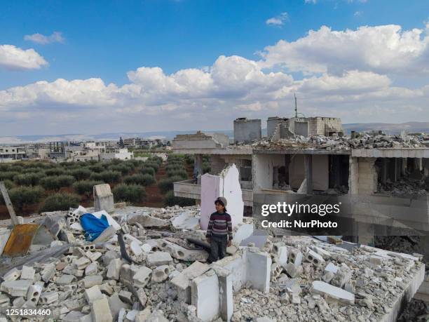 Children climb up multi-story buildings that are prone to collapse and are dangerous as a result of the earthquake, in search of what can be salvaged...