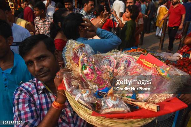 Person carrying Hindu gods Devi Laxmi, and Ganesha during a ritual on the first day of the Bengali New Year inside a temple in Kolkata, India on 15...
