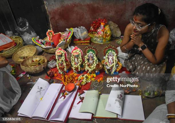 Hindu devotee worship idols of Hindu gods Ganesh, the deity of prosperity, and goddess of wealth Laxmi, during a ritual on the first day of the...