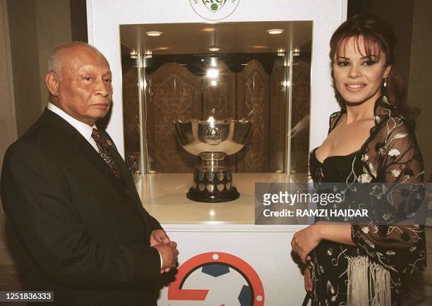 Asian Football Confederation head Sultan Ahmad Shah stands with Miss Lebanon 2000 Norma Naoum in front of the Asia Cup at Beirut's recently re-opened...