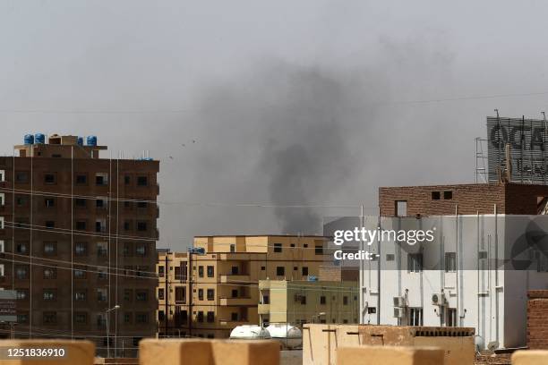 Smoke rises above buildings in Khartoum on April 15 amid reported clashes in the city. The Sudanese army said on April 15 that paramilitaries...