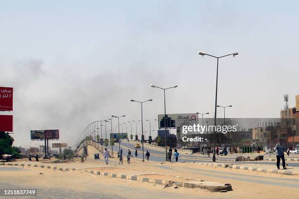 Smoke rises above buildings in Khartoum on April 15 amid reported clashes in the city. Sudan's paramilitaries said they were in control of several...