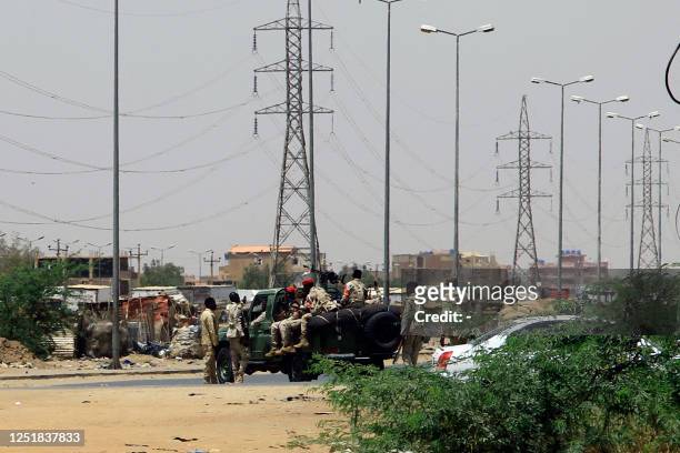 Army soldiers deploy in Khartoum on April 15 amid reported clashes in the city. Sudan's paramilitaries said they were in control of several key sites...