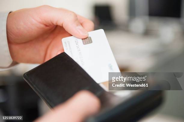 hands of man holding wallet and blank white credit card - wallet stock pictures, royalty-free photos & images