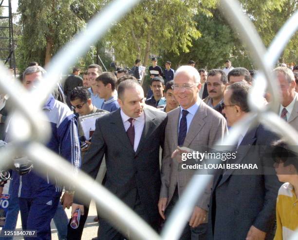 Former German football star and Chairman of Germany's Bayern Munich, Franz Beckenbauer walks with Syrian member of the FIFA technical committee and...