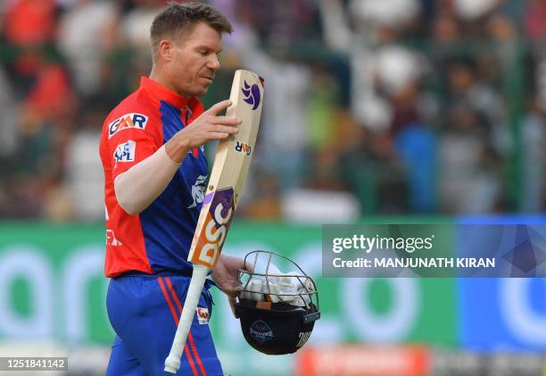 Delhi Capitals' David Warner walks back to the pavilion after his dismissal during the Indian Premier League Twenty20 cricket match between Royal...