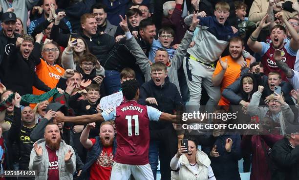 Aston Villa's English striker Ollie Watkins celebrates in front of fans after scoring their second goal during the English Premier League football...