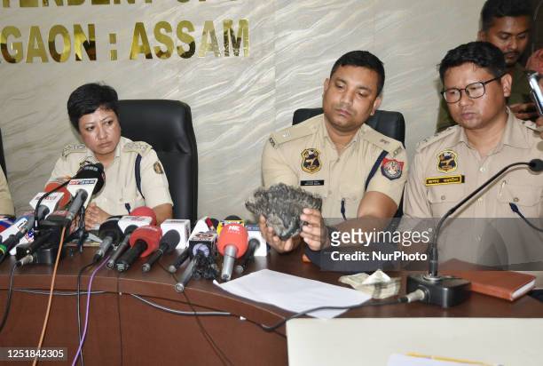 Assam police officials display a rhino horn sezied from smuggler identified as Hatem Ali after conducted a search operation in Nagaon District of...