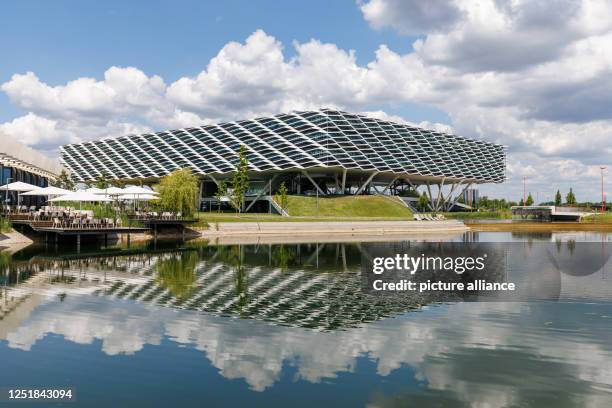 June 2022, Bavaria, Herzogenaurach: The "Arena" office building at the headquarters of the sporting goods manufacturer adidas AG is reflected in an...