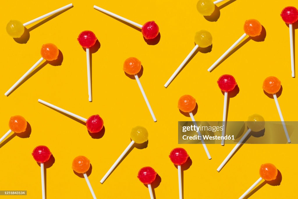 Pattern of lollipops against yellow background