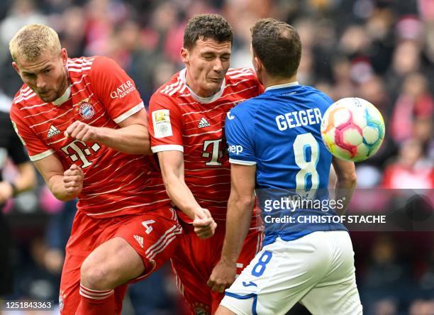Bayern Munich's Dutch defender Matthijs de Ligt, Bayern Munich's French defender Benjamin Pavard and Hoffenheim's midfielder Dennis Geiger vie for...