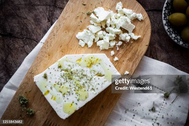 feta cheese on cutting board - feta cheese stock pictures, royalty-free photos & images