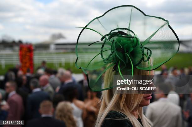 Racegoers attend the final day of the Grand National Festival horse race meeting at Aintree Racecourse in Liverpool, north-west England, on April 15,...