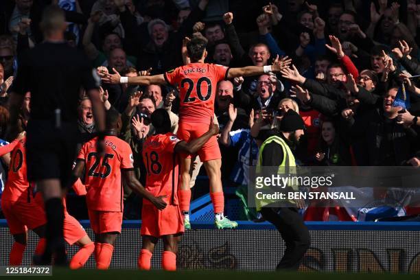 Brighton's Paraguayan striker Julio Enciso celebrates with teammates in front of fans after scoring their second goal during the English Premier...