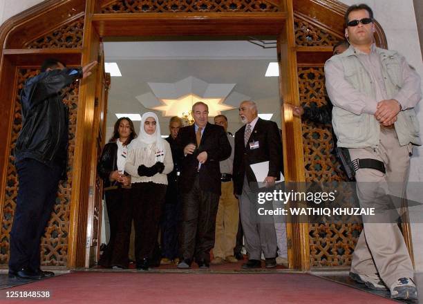 Iraqi interim Prime Minster Iyad Allawi walks next to the President of the Iraqi National Olympic Committee Ahmed al Samarrai and Iraqi athletes...