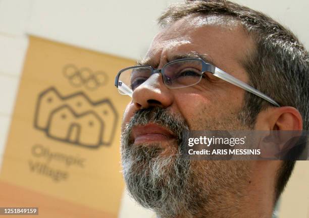 Costas Tsingos, the chef of the Game's athlete's Olympic village looks on as the official sign of the Olympic village is seen at the background in...