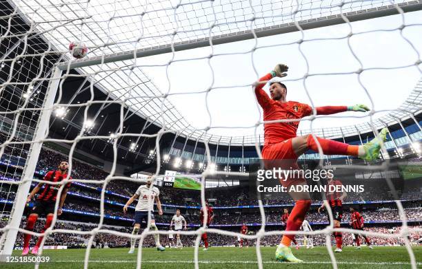 Bournemouth's Brazilian goalkeeper Neto eyes the ball bouncing on the bar during the English Premier League football match between Tottenham Hotspur...