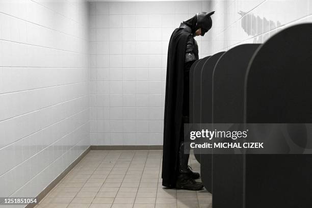 Cosplayer dressed as batman is seen in toilet during the 'Comic-Con' festival in Prague, Czech Republic, on April 15, 2023. - The three day...