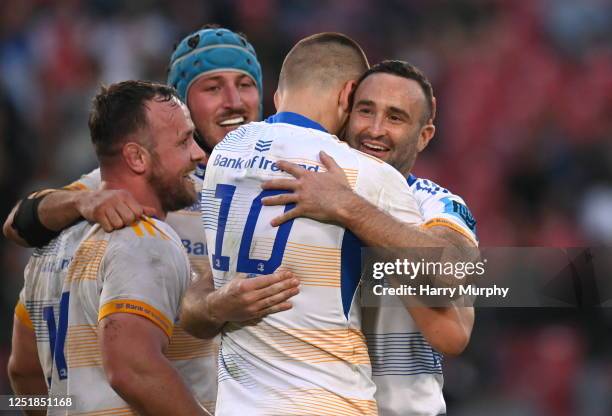 Gauteng , South Africa - 15 April 2023; Sam Prendergast of Leinster is embraced by teammates Ed Byrne, Will Connors and Dave Kearney after kicking a...