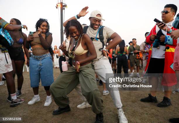 Azarine Ledwidge of New York City, left, and Ten Francis of Los Angeles, right, dance during Burna Boy's performance at Coachella weekend one on...