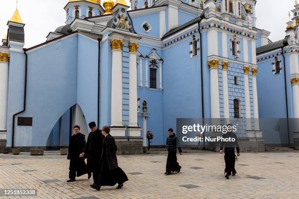 Monks walk on the yard in St. Michael's Golden-Domed Monastery in Kyiv, the capital of Ukraine on Orthodox Easter Saturday Most of Ukrainians are...