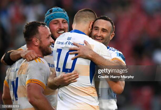 Gauteng , South Africa - 15 April 2023; Sam Prendergast of Leinster is embraced by teammates Ed Byrne, Will Connors and Dave Kearney after kicking a...
