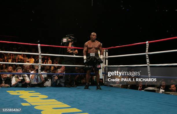 Former heavyweight champion Mike Tyson waits in the "neutral corner" after inflecting a ruled intentional head-butt against opponent Kevin McBride of...