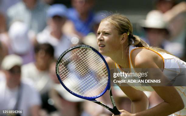 Defending Wimbledon Ladies champion Maria Sharapova of Russia waits for the serve from Nuna Llagostera Vives of Spain during their first round match...