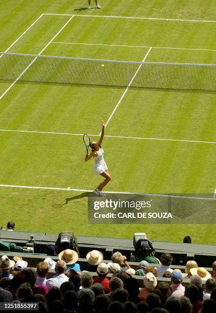 Maria Sharapova of Russia serves to Nuna Llagostera Vives of Spain during their first round match at the 119th Wimbledon Tennis Championships in...