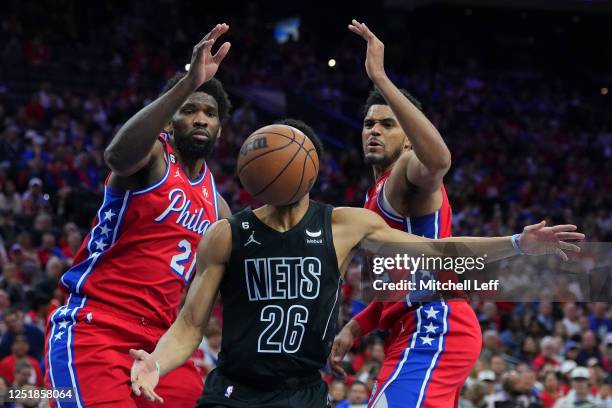 Spencer Dinwiddie of the Brooklyn Nets loses control of the ball against Joel Embiid and Tobias Harris of the Philadelphia 76ers in the third quarter...