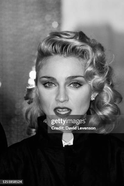 Singer Madonna holds a Press Conference with former Beatle George Harrison for their film 'Shanghai Surprise' at the Kensington Roof Gardens in...